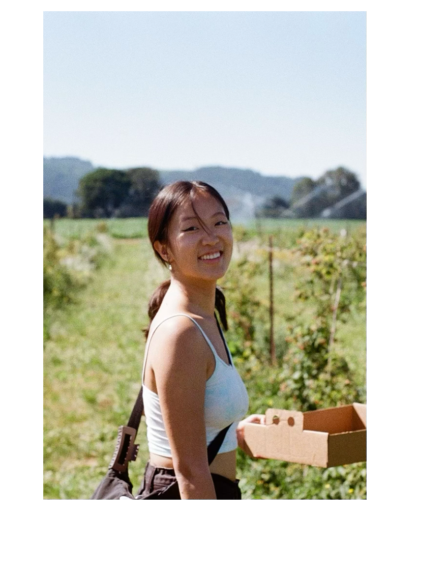 Catherine picking berries on a farm